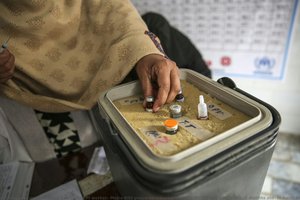 An Epi Worker, Majra Bibi Prepares Measles Vaccine For Mawah Roohullah (9 Months Old) In Basic Health Unit Akora Ii, Pakistan — Dr Asad Zaidi