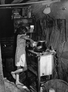 Oldest Child Of Migrant Packing House Workers Preparing Supper. Her Parents Work During The Day And Sometimes Until 2 A.m. The Children Are Left Alone. Near Homestead, Florida — Marion Post Wolcott