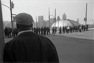 A Man Watches As Armed Police Barricade The Street Before Pittsburgh Peace March — Charles Martin Hardie