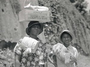Two Negro Women Carrying Packages, One Has A Box Of Surplus Relief Commodities On Her Head. Natchez, Mississippi — Marion Post Wolcott