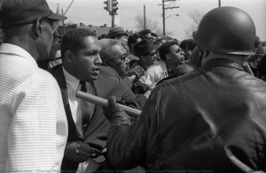 A Police Officer Raises His Baton During Pittsburgh Peace March — Charles Martin Hardie