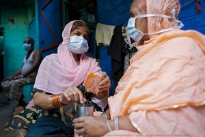 A Woman Provides Ors (oral Rehydration Salts) For Her Mother In A Delhi Slum — Thomas Matthew Crooks