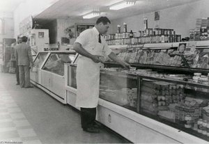 Louis Menotti at semi self service counter, first in Galveston, 1949, from The Corner Stores of Galveston, Galveston County Cultural Arts Council